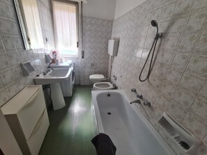 Ein Badezimmer mit Waschbecken, Toilette und Badewanne.