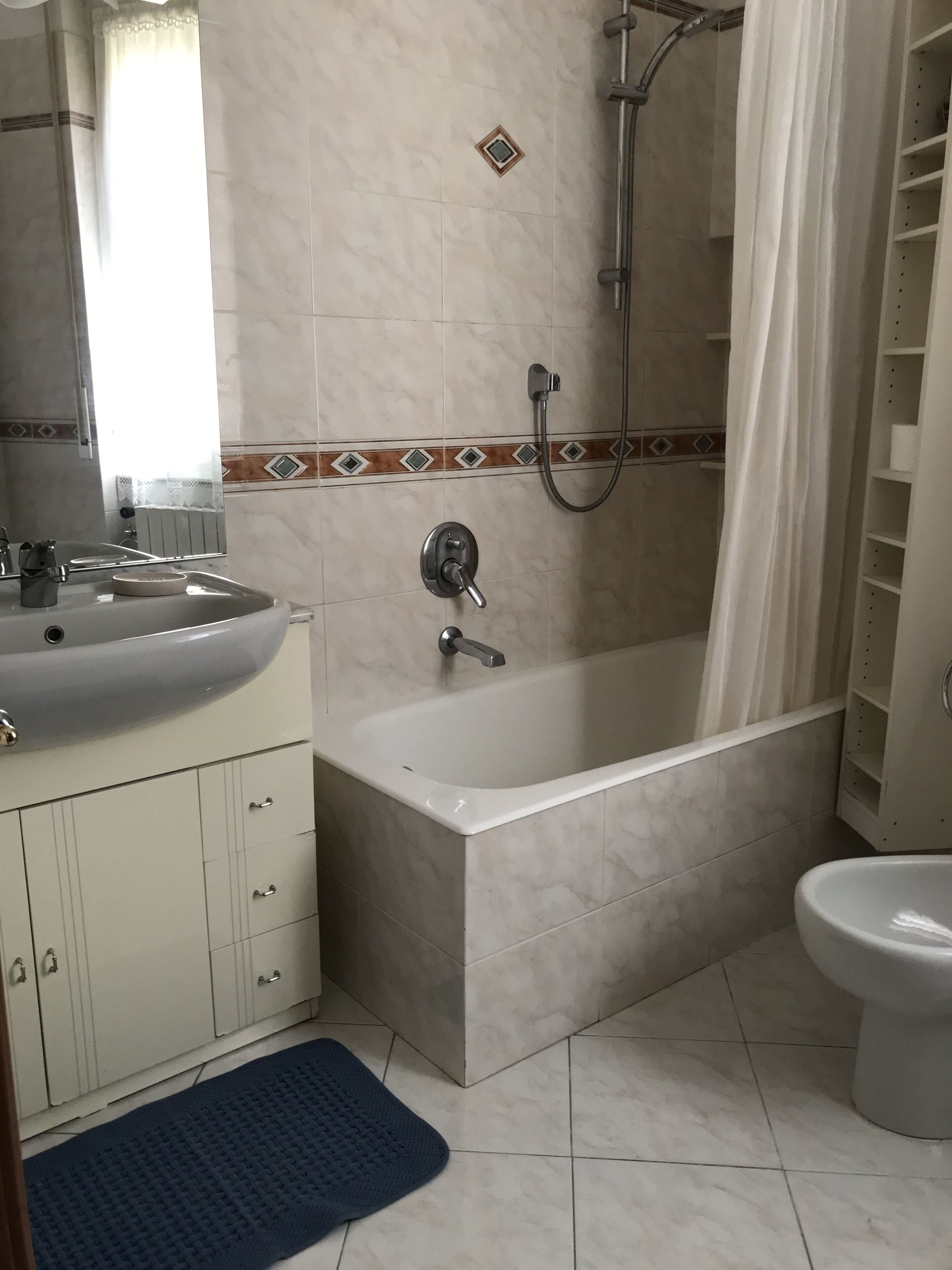A bathroom with a bathtub, a toilet, and a sink.