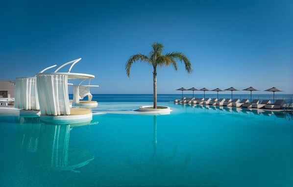 Seasonal outdoor pool, open 8:30 AM to 8:00 PM, pool umbrellas