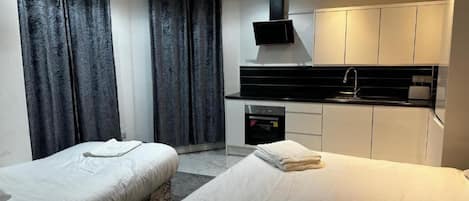 Deluxe Triple Room, Multiple Beds (Studio) | Desk, free WiFi, bed sheets