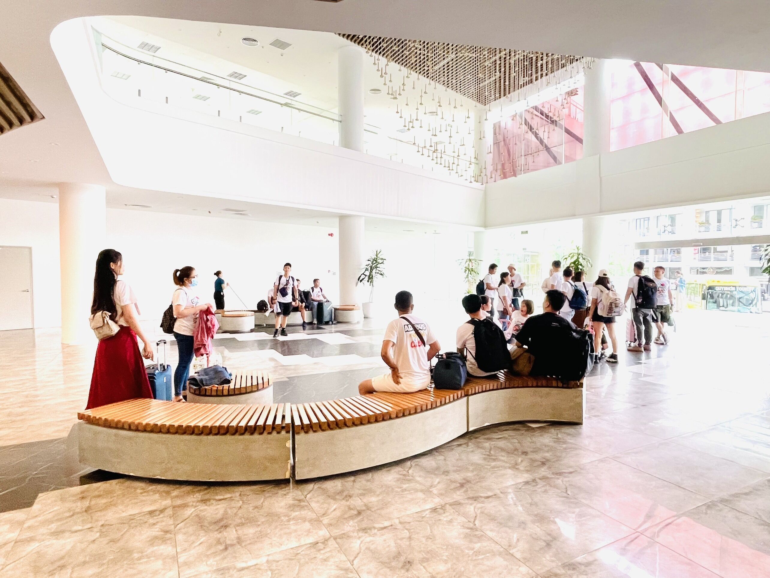 A spacious lobby with a high ceiling and a central seating area.