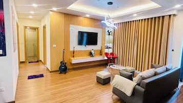 Premium Apartment | Living area | 55-inch Smart TV with satellite channels