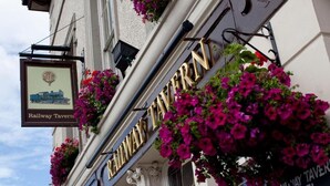 A building with a sign that reads "Railway Tavern" and another sign that reads "Railway Tavern Hotel." - The Railway Tavern Hotel (London)