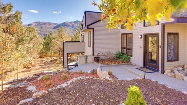 A modern house with a landscaped yard, a front door, and a view of mountains in the background. - Near Trails! Sun-Drenched Durango Escape w/ View (Durango)