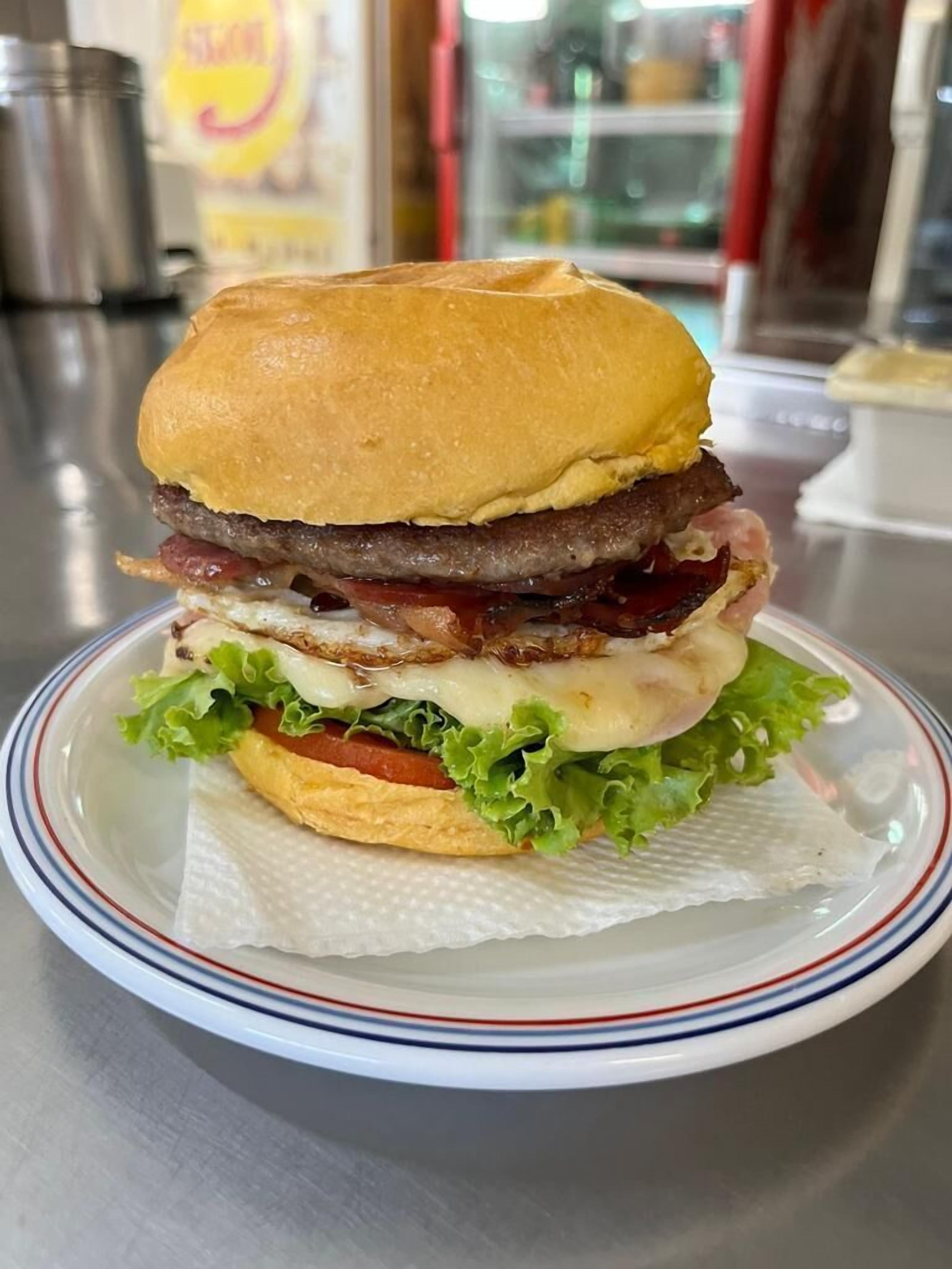 A sandwich on a plate with a paper liner.