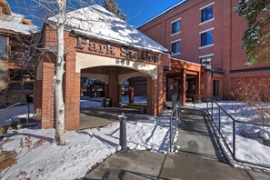 A brick building with a sign reading "Park Station 950" and a covered entrance with a metal railing.