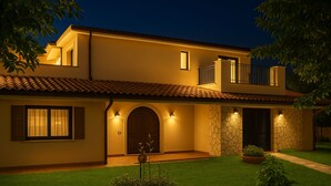 A two-story house with a tiled roof, a stone facade, and a well-lit entrance. - Geranium | 2 bedroom, 2 bath, penthouse near the sea (Anastasi III)