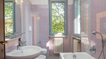 A bathroom with a bathtub, a sink, and a toilet.