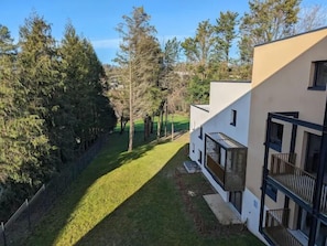 A modern building with a flat roof, large windows, and a visible balcony. - Zenao Appart'hôtels Montivilliers (Montivilliers)