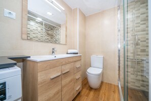 Shower, hair dryer, towels, toilet paper
