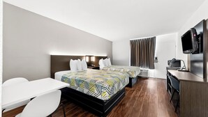 A hotel room with two beds, a desk, a chair, a TV, and a kitchenette. - Motel 6 Port Lavaca, TX (Port Lavaca)