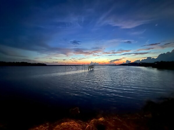 A calm body of water with a pier extending into it. - Blue Crab Condo at Rivers Edge (Steinhatchee)