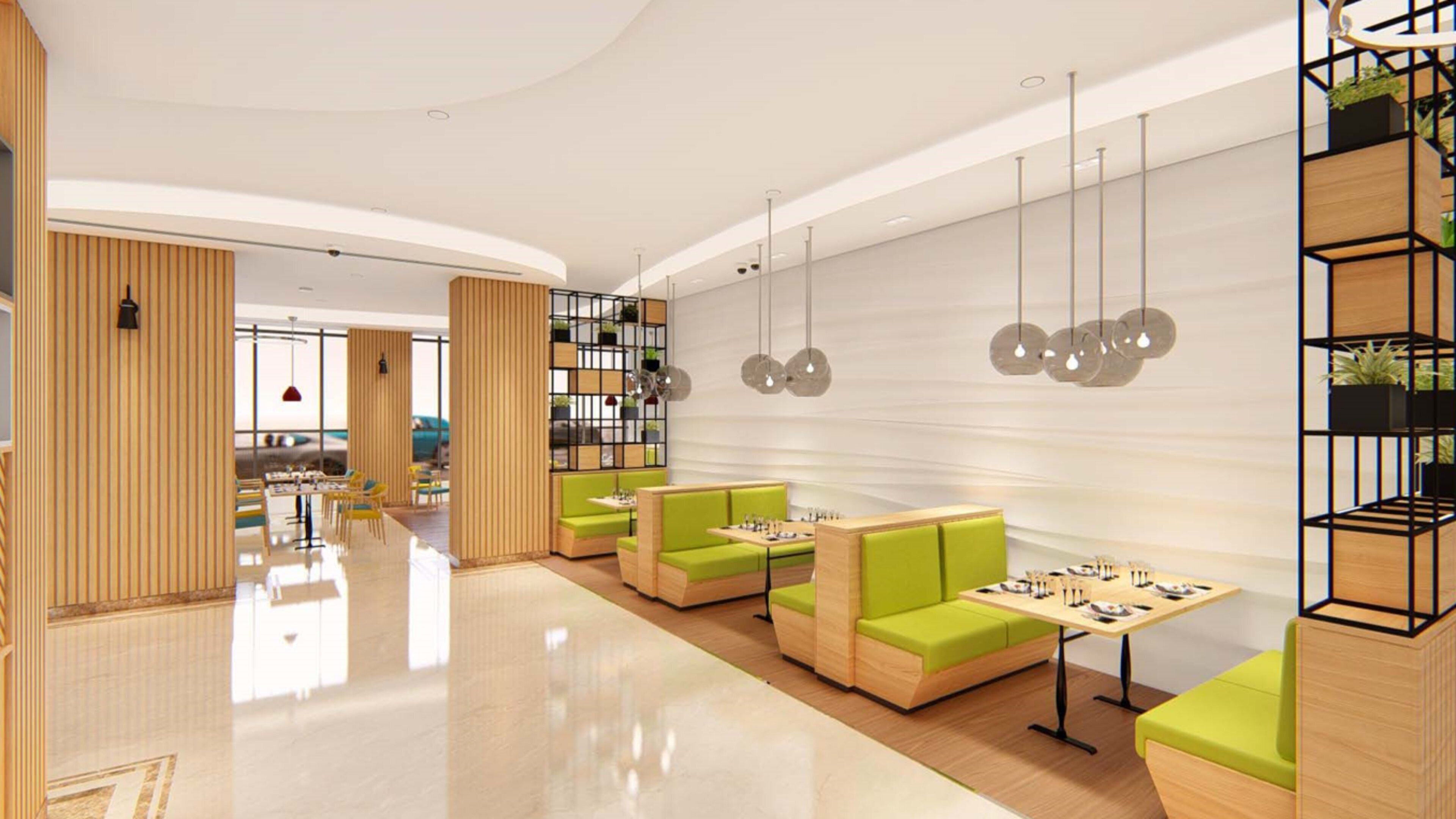 A modern interior with seating areas, a dining space, and a bookshelf.