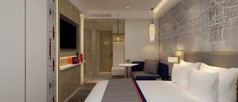 A hotel room with a large bed, a seating area, a TV, and a wall with a detailed mural.