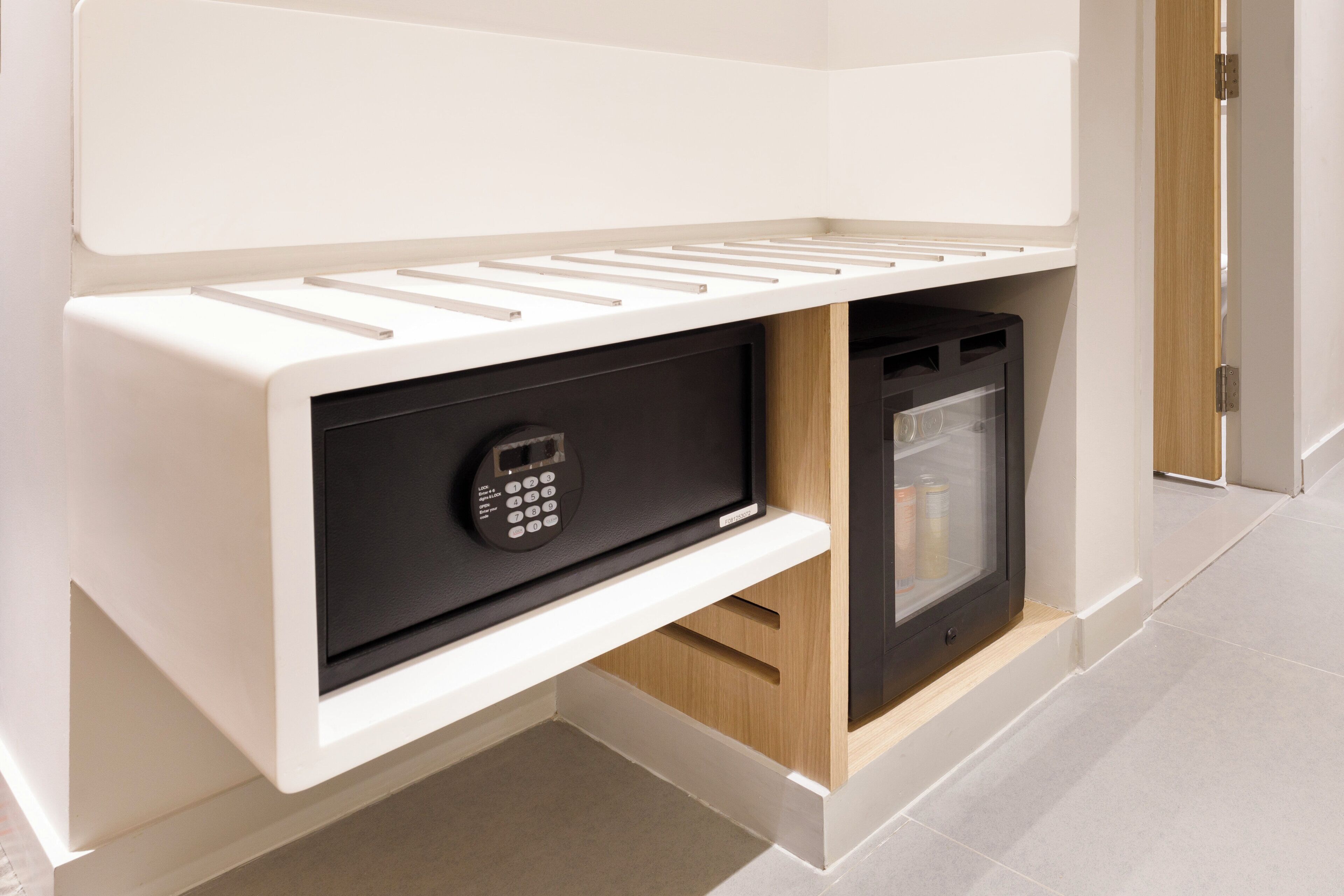 A modern kitchen with built-in appliances, a microwave, and a refrigerator.