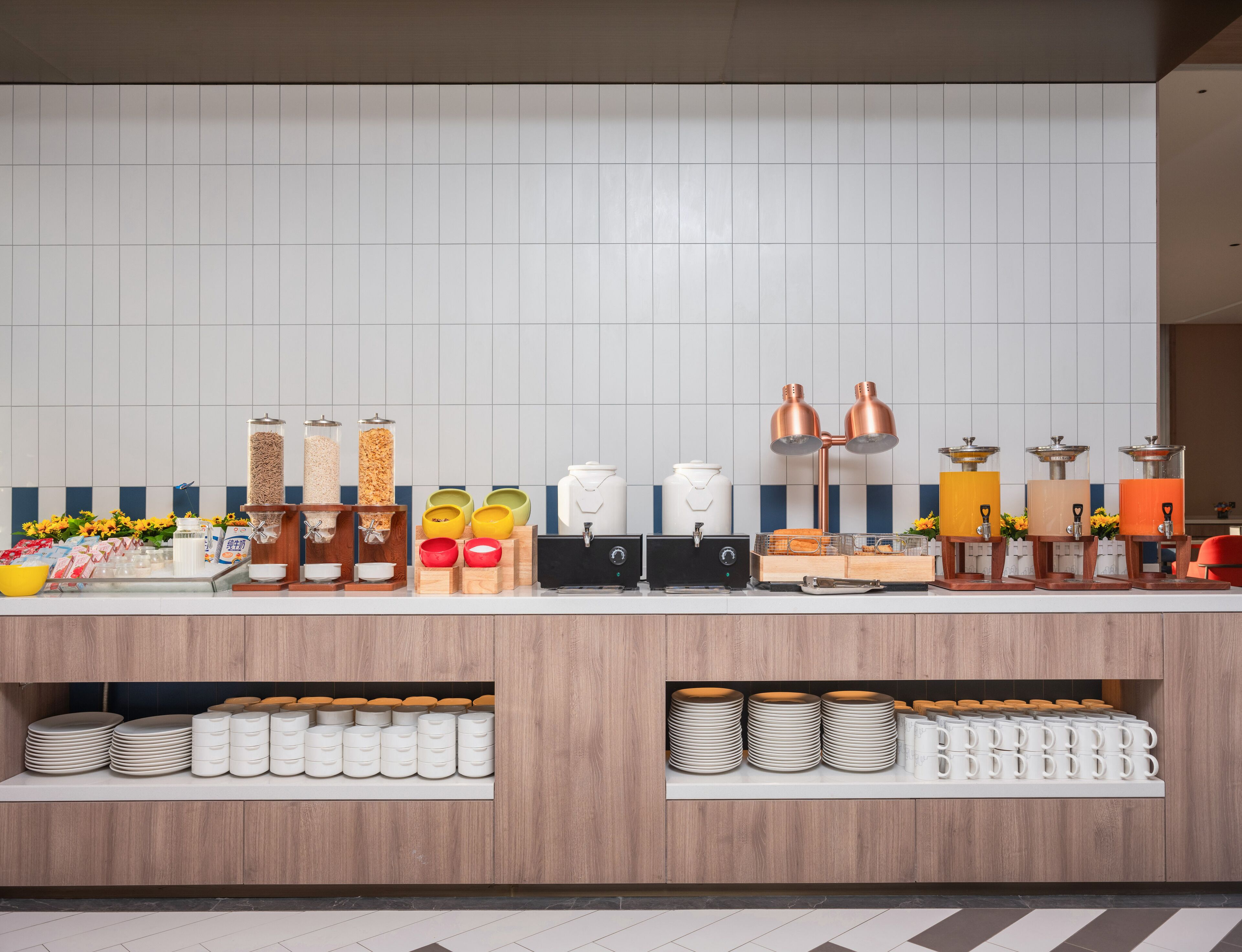 A modern kitchen with a white tiled backsplash, stainless steel appliances, and wooden cabinets.
