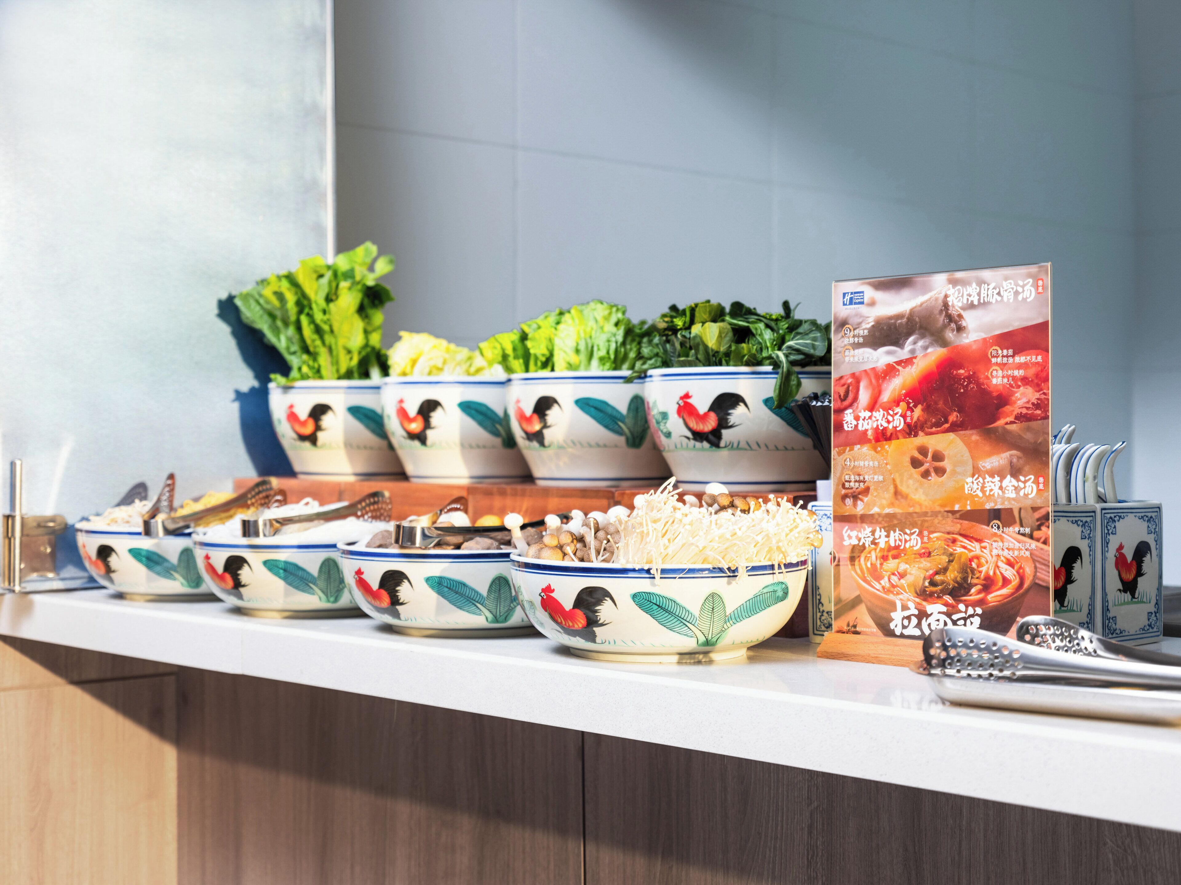 A buffet table with various dishes and condiments.
