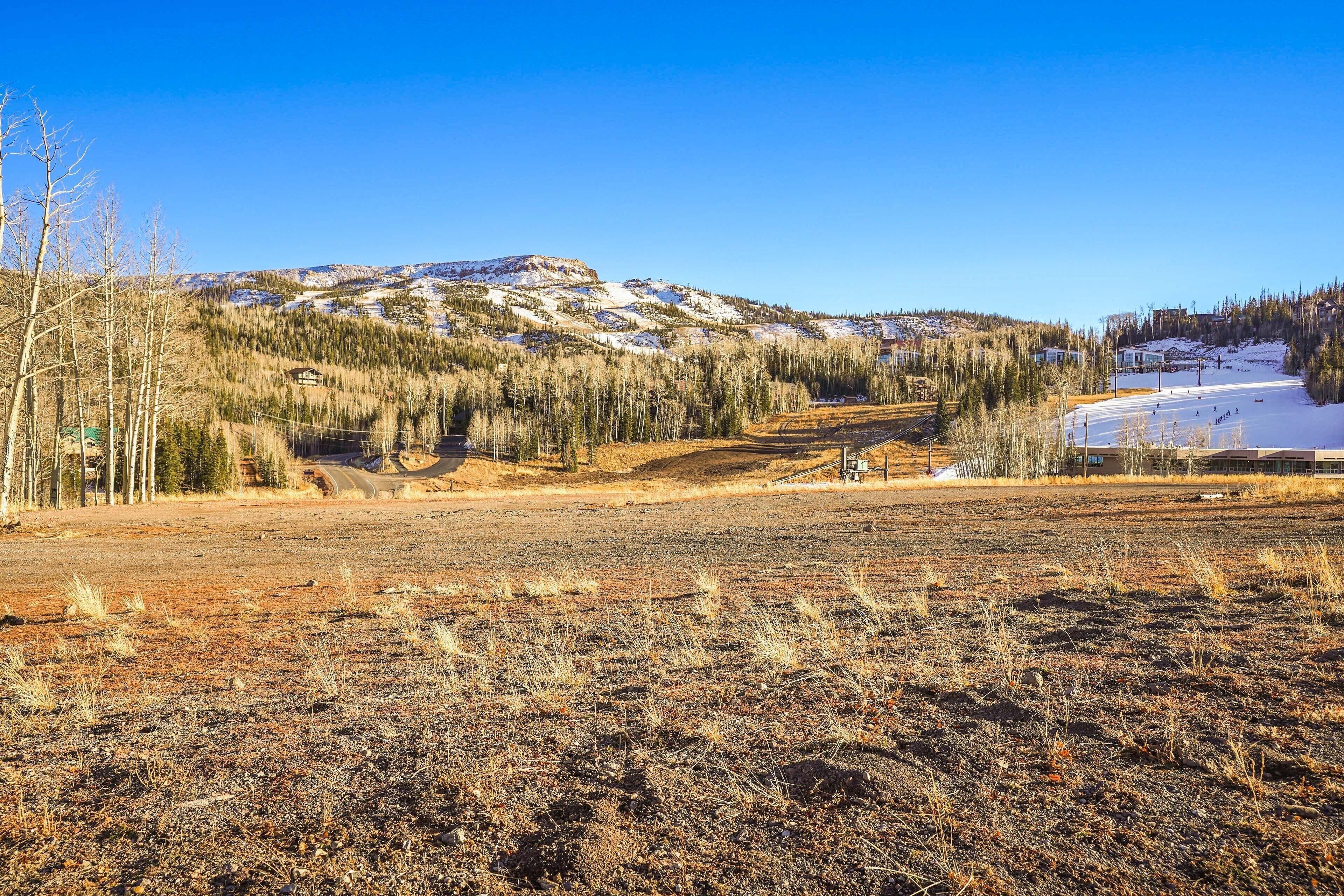 A mountainous landscape with a ski resort in the background.