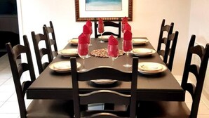 A dining table set for six with black chairs, a framed picture on the wall, and a window in the background. - Cozy single-family home, close to theme parks, restaurants. Give Kids the World. (Kissimmee)