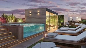 A modern outdoor pool area with lounge chairs and a hot tub. - Syl's New Spacious Patio Pad (Miraflores)