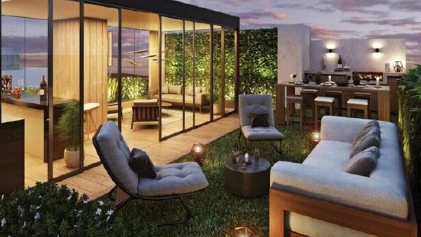 A modern outdoor living area with a glass-enclosed space, a bar area, and comfortable seating. - Syl's New Spacious Patio Pad (Miraflores)