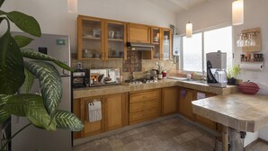 A kitchen with wooden cabinets, a gas stove, and a sink.