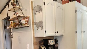 A kitchen with white cabinets, a wooden countertop, and a coffee maker. - Animal Village/W/Mountain Views (Kalispell)