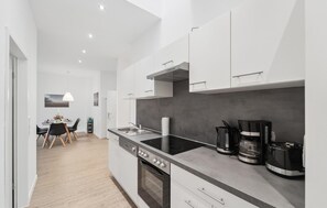 Fridge, stovetop, dishwasher, coffee/tea maker
