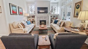 Smart TV, fireplace, books, computer monitors