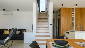 A modern living space with a staircase leading to a kitchen area. - 3 bedroom beautiful home in Porec (Porec)