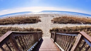 A wooden staircase leading to a beach with a clear view of the ocean. - 15th Floor Oceanfront Condo with Beach, 4 Pools, 2 Hot Tubs & a Lazy River (Myrtle Beach)