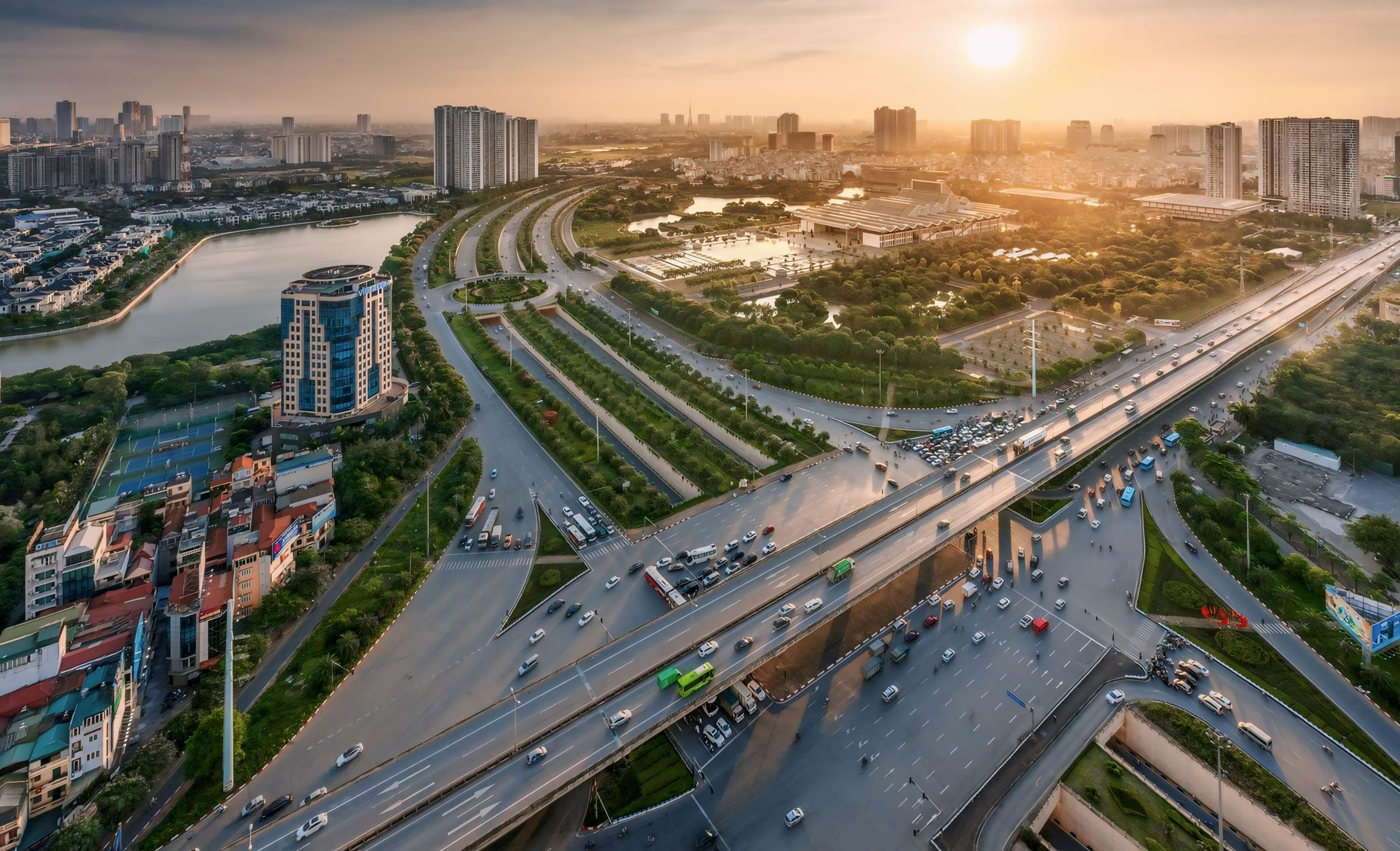 A multi-level highway interchange with vehicles, surrounded by urban buildings and greenery.
