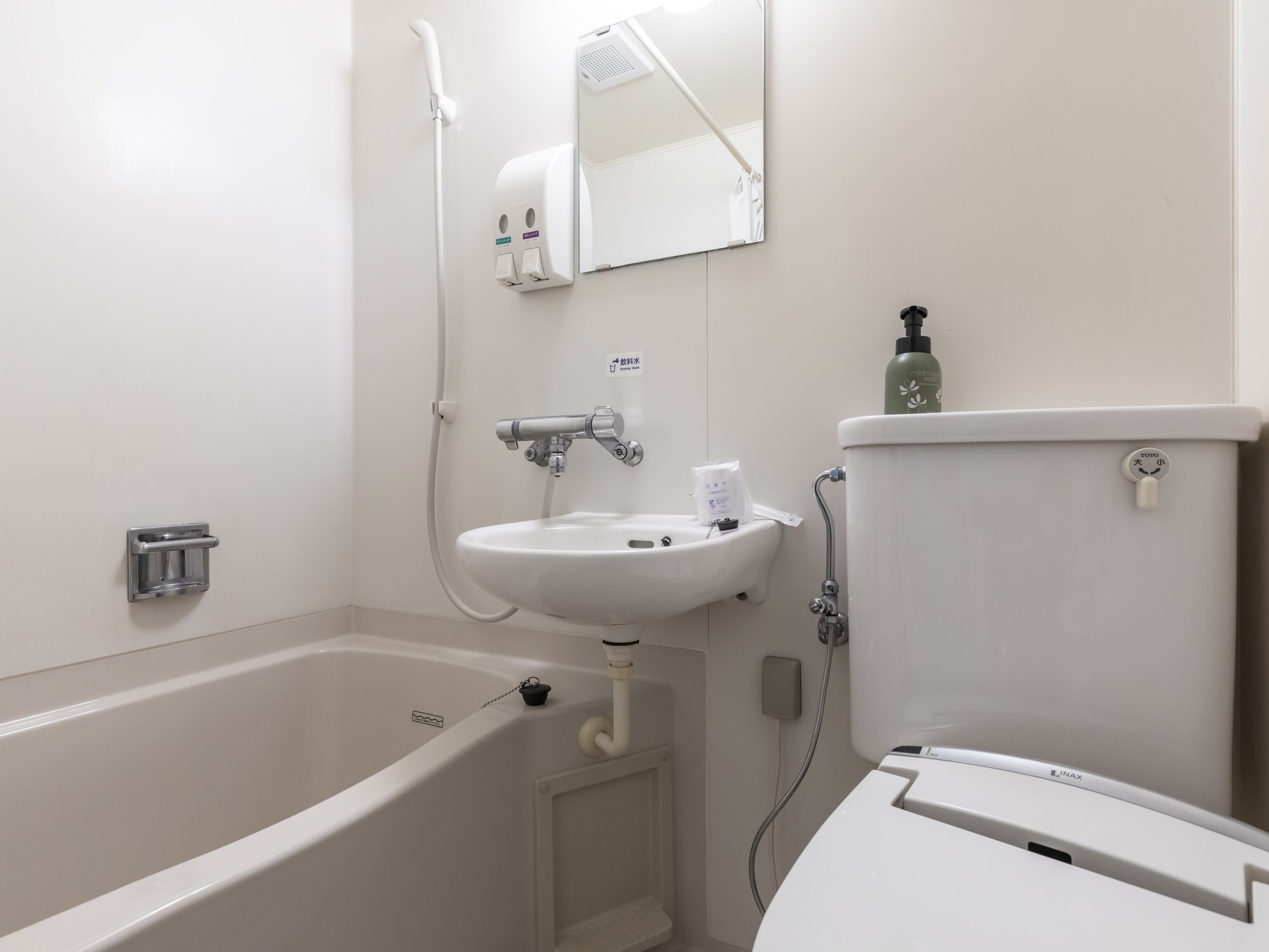 A bathroom with a bathtub, sink, and toilet.
