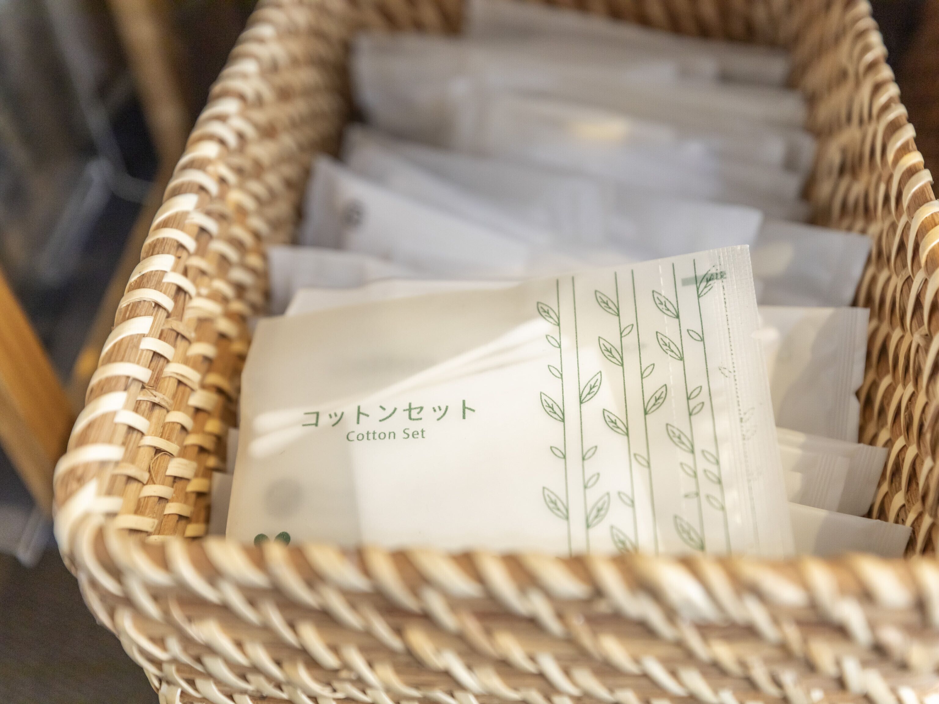 A wicker basket filled with white tissue paper labeled "Cotton Set".