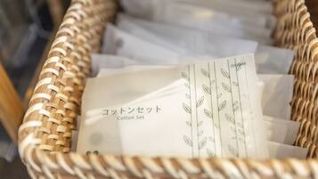 A wicker basket filled with white tissue paper labeled "Cotton Set".