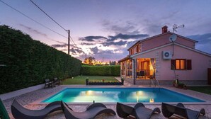 Una casa con piscina y zona de estar al aire libre.