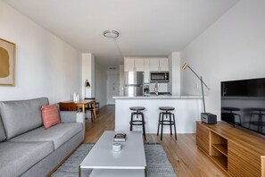 Relax in this stylish living space with a sofa, coffee table, and flat-screen TV.