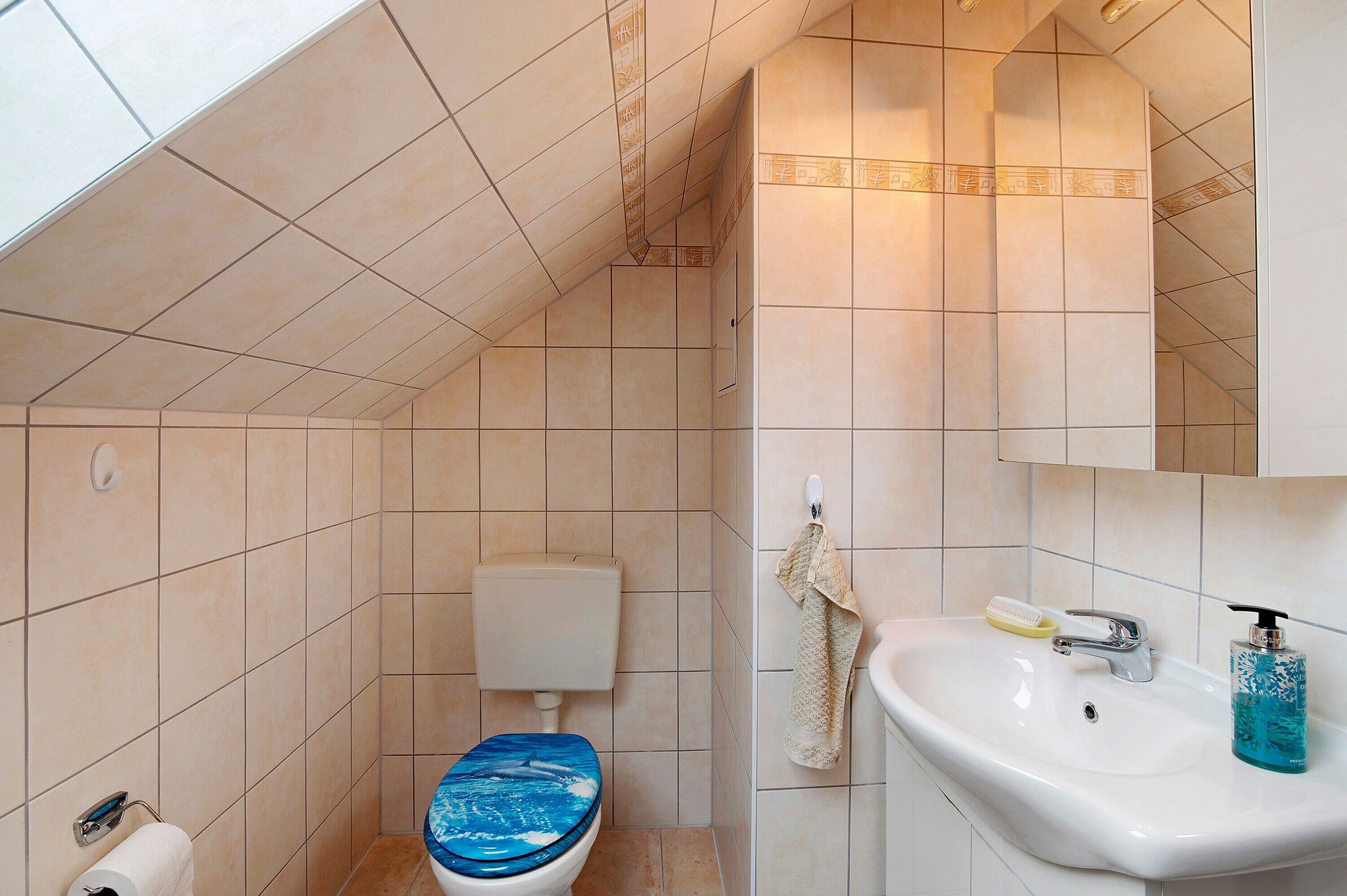 Ein Badezimmer mit Toilette, Waschbecken und Handtuchhalter.