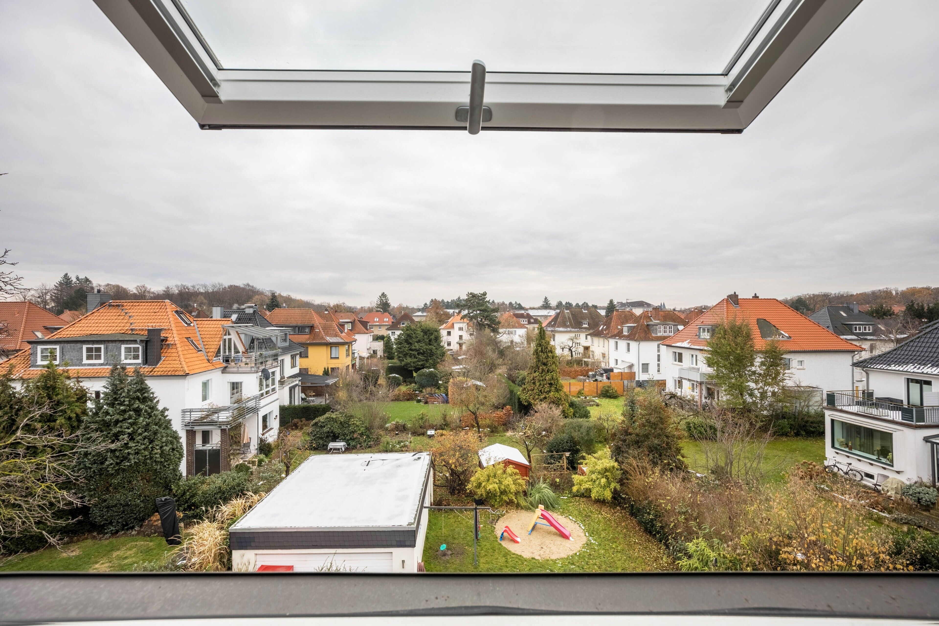 A residential area with houses, a playground, and a view through a skylight.