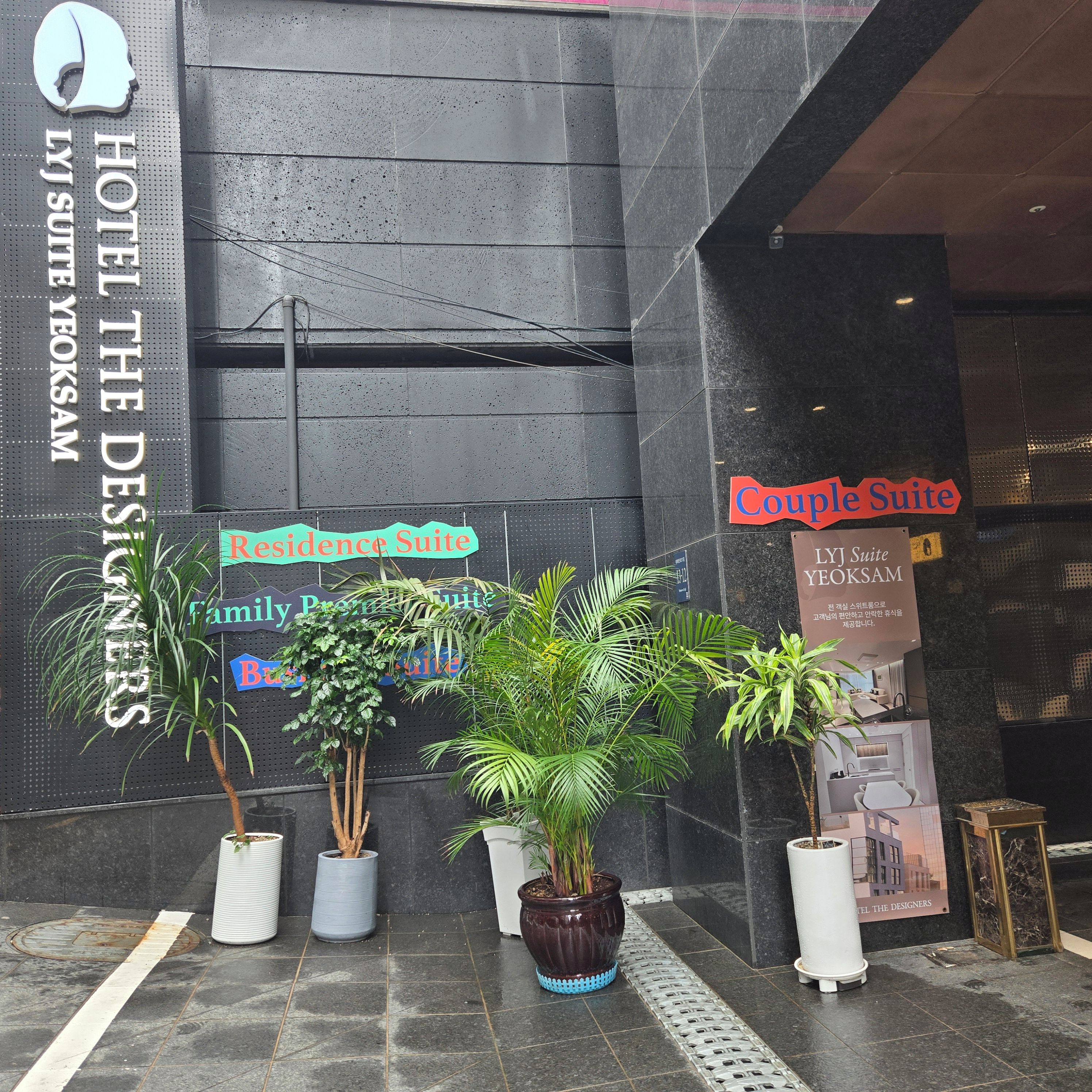 A hotel entrance with signage for 'Hotel The Designers' and 'LJ Suite Yeoksam'.
