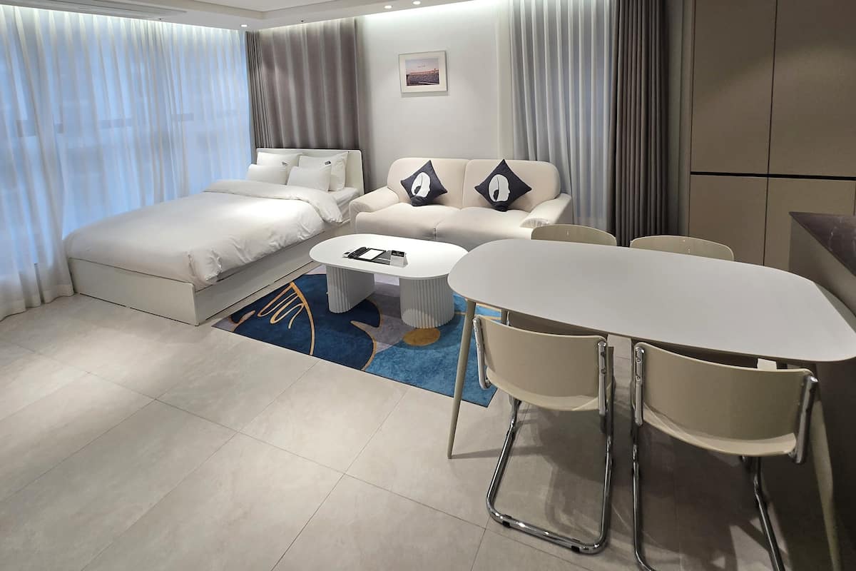 Family Suite, 1 Bedroom, Non Smoking, City View | Living area | 65-inch Smart TV with cable channels, Netflix, pay movies
