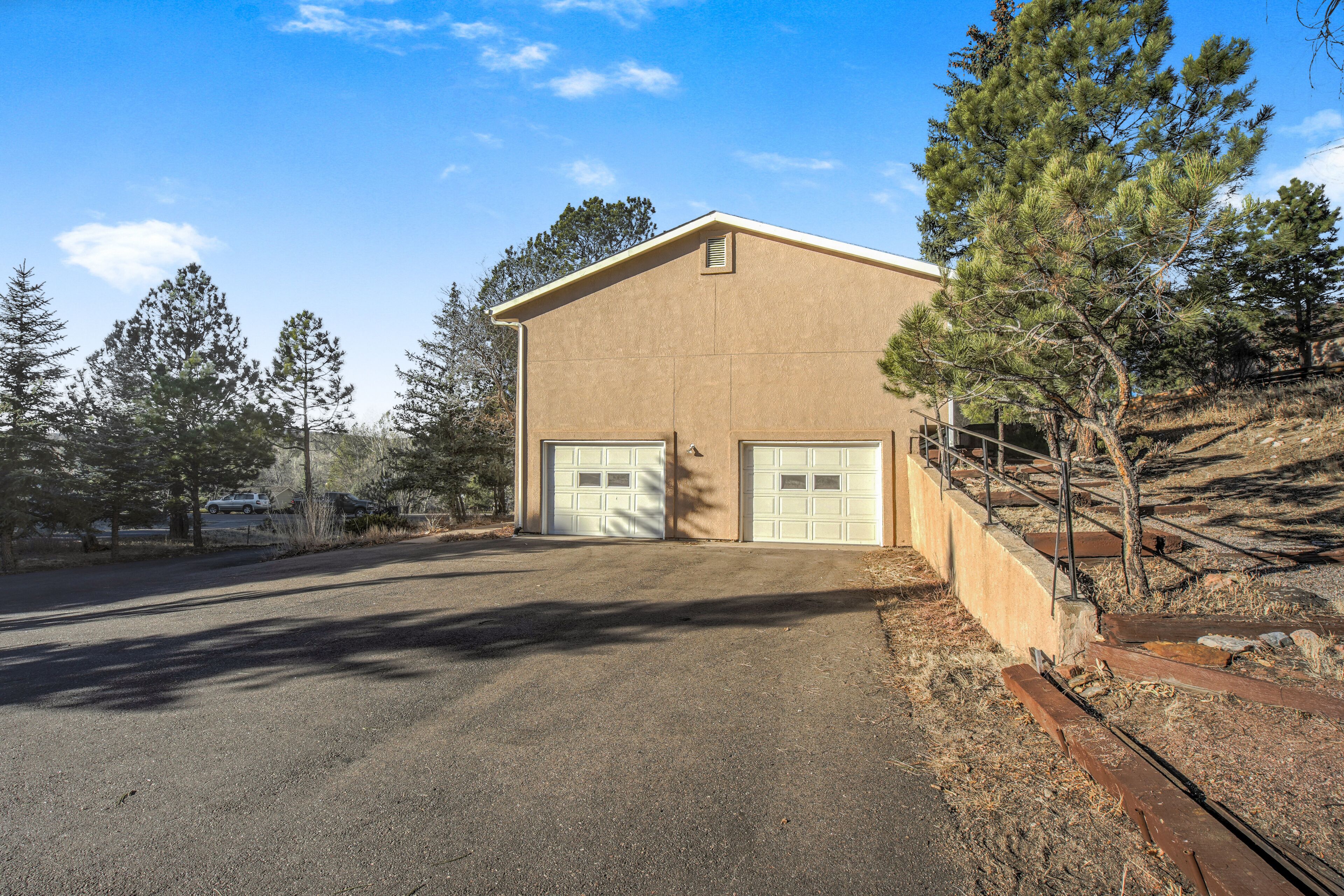 A two-story building with a garage and a driveway.