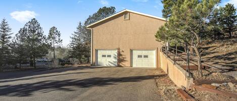 A two-story building with a garage and a driveway.
