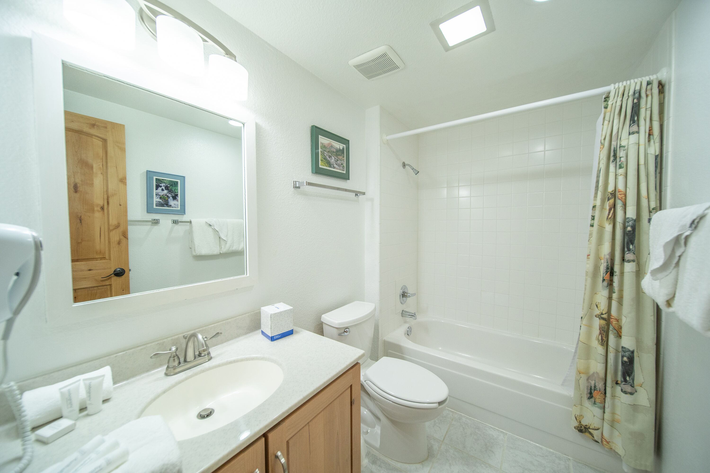 A bathroom with a sink, toilet, and bathtub.
