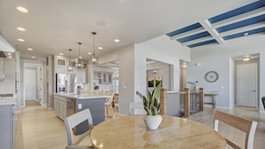 A modern kitchen with white cabinets, stainless steel appliances, and a central island.