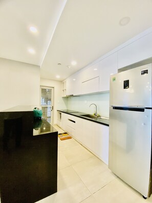 Standard Apartment | Private kitchen | Full-sized fridge, microwave, stovetop, rice cooker - Tony Apartment Scenic Valley (Ho Chi Minh City)