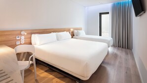 A modern hotel room with a large bed, a desk, and a chair. - B&B Hotel Olhao Algarve (Olhao)