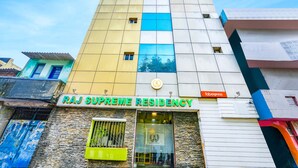 A multi-story building with a sign reading "RAJ SUPREME RESIDENCY". - Fabexpress Raj Supreme Residency (Chennai)