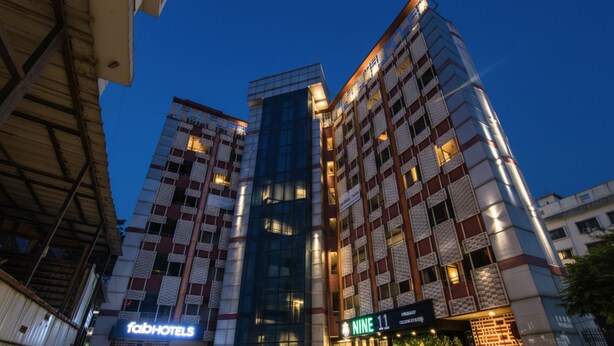 A multi-story hotel with a modern facade, featuring a prominent 'NINE 11' sign at the ground level. - Fabhotel Moro Rohini Sector 11 (New Delhi)