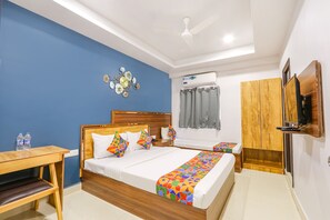 Relax in this stylish room with a large bed, desk, and comfortable chair.